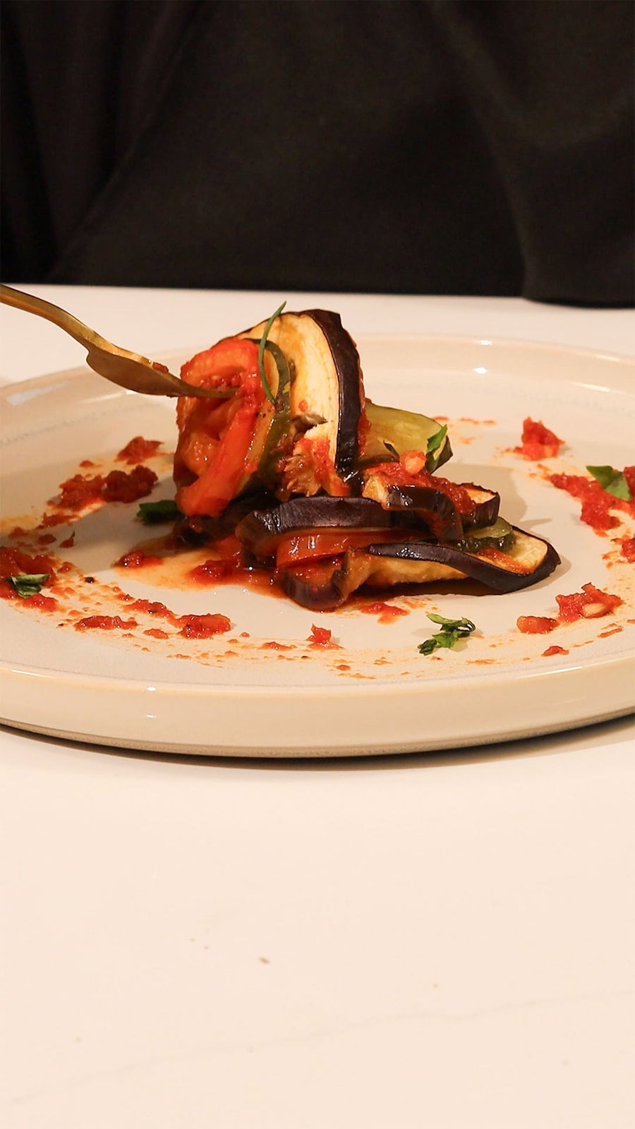 Ratatouille with roasted vegetables plated in a fine-dining style