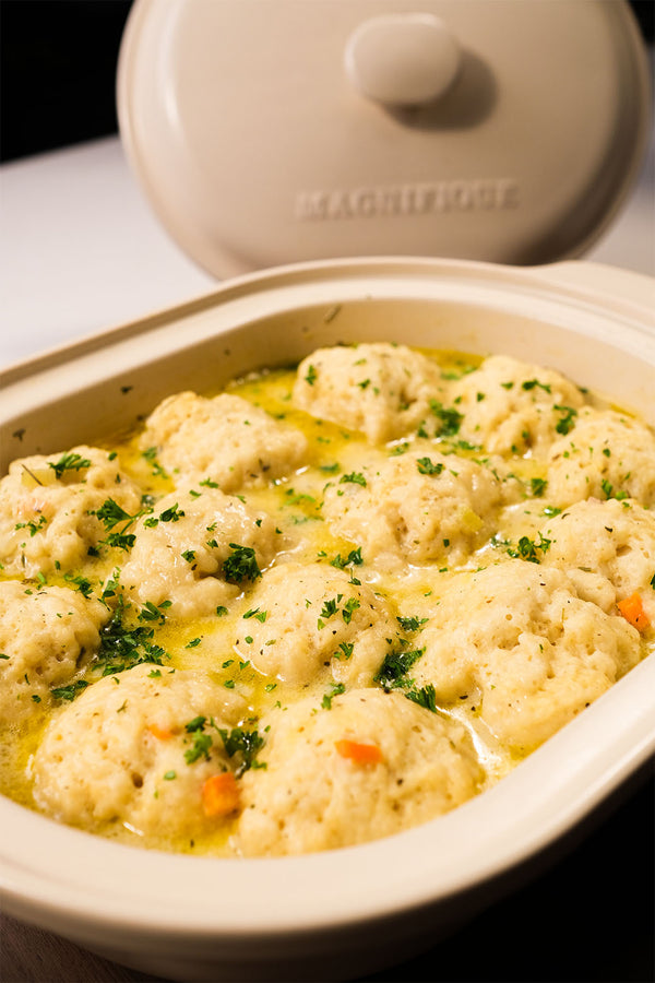 Creamy chicken and dumpling soup with fluffy dumplings in a claypot