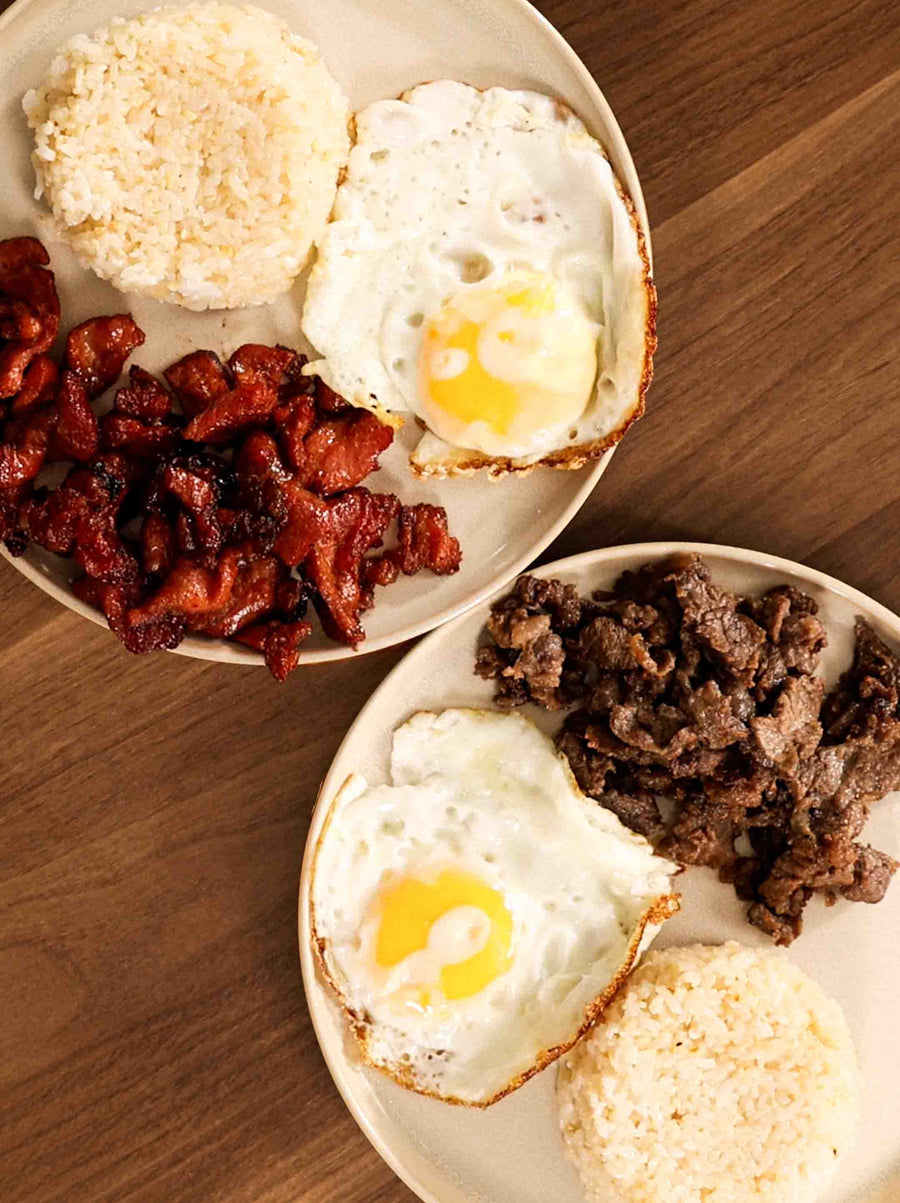Two plates of delicious Tapsilog and Tocilog on a wooden table. 