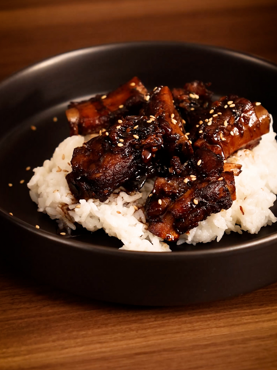 A plate of rice with delicious Sweet and Sour Pork Ribs on top made in the Claypot Cooker. 