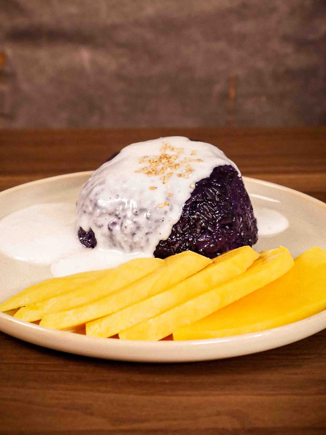 A plate of Ube Mango Sticky Rice, with Coconut Sauce and Sesame Seeds on top. Made in the Flami Pot. 