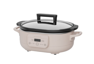 The Slow Cooker in a light color with a glass lid and digital controls for easy cooking.