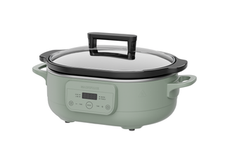 The Slow Cooker in a stylish green color with a glass lid, perfect for versatile meal preparation.