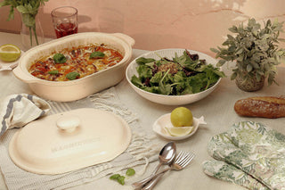 The Claypot: Pot & Lid Set on a table with salad, garnished with herbs, showcasing toxic-free cookware.