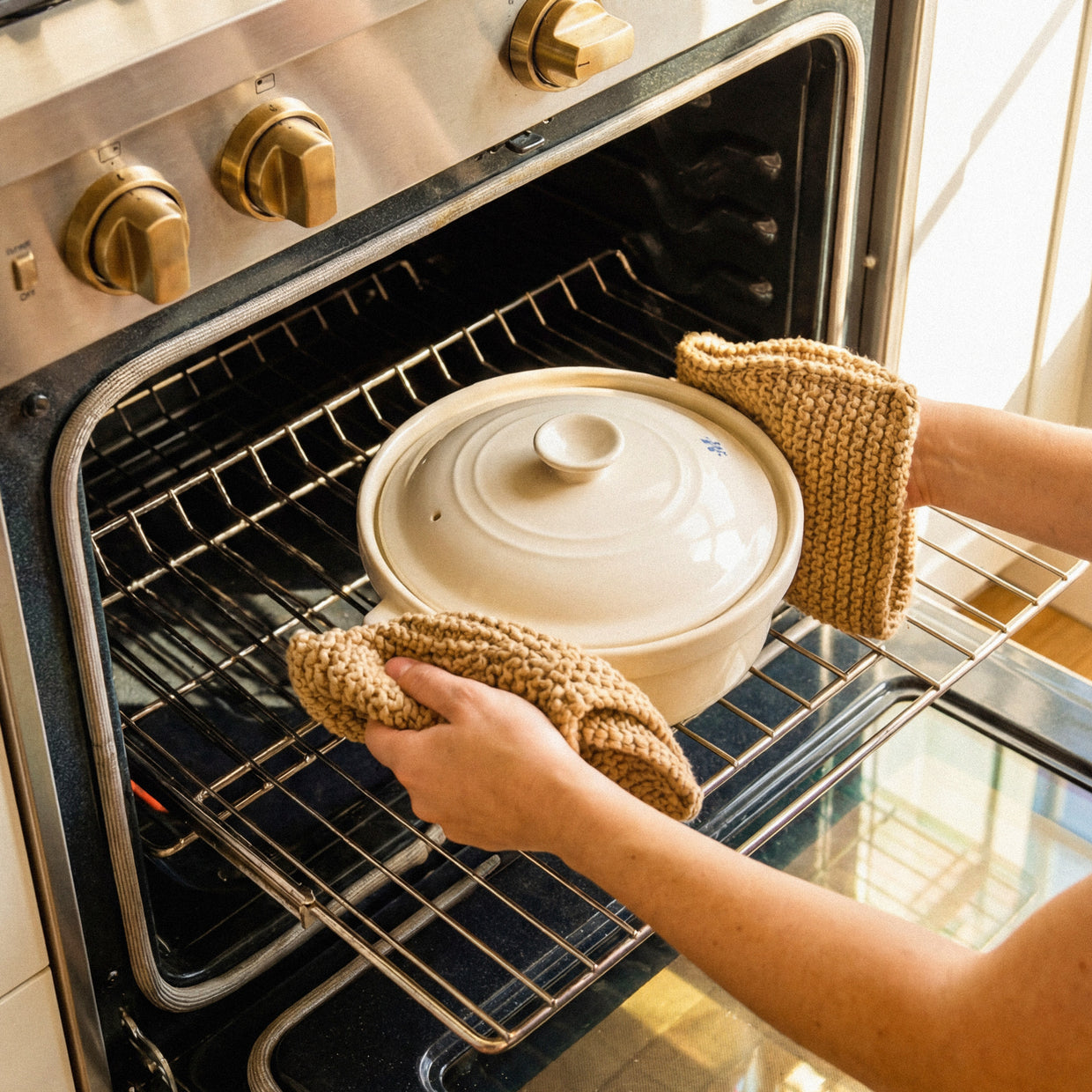 The Flami Pot being removed from the oven, showcasing non-toxic cookware for chemical-free cooking.