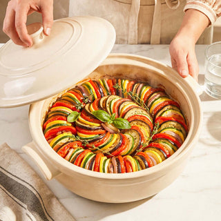 The Flami Pot with a colorful ratatouille dish, showcasing its non-toxic clay cookware aesthetic.