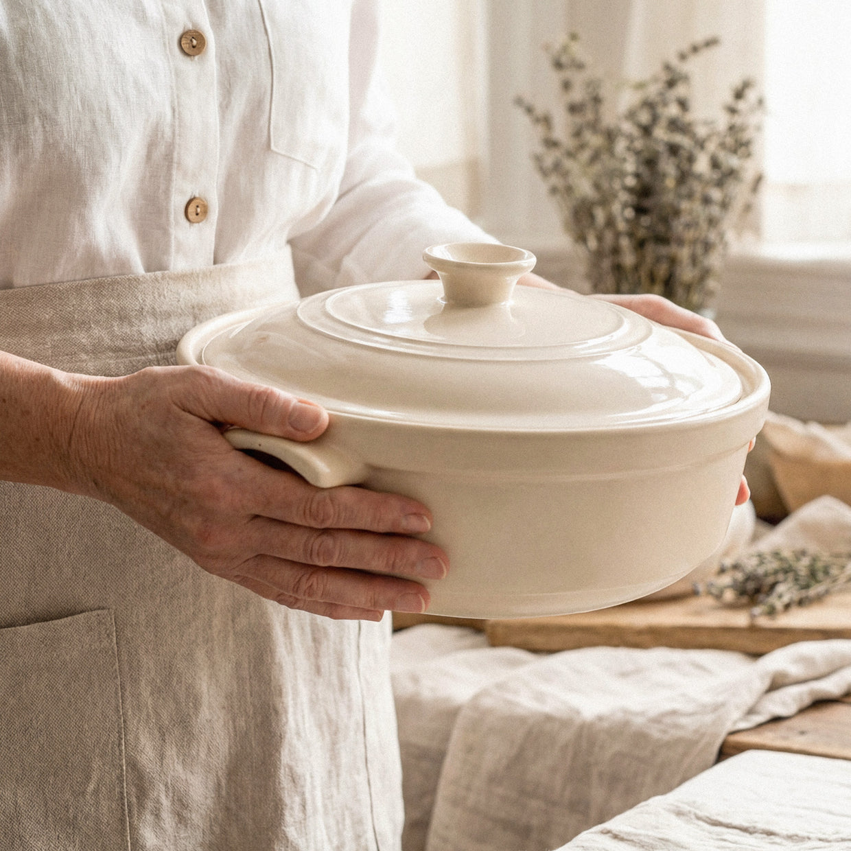 A person holding The Flami Pot, handcrafted non-toxic cookware perfect for chemical-free cooking.