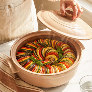 The Flami Pot showcasing colorful ratatouille, highlighting its non-toxic clay cookware and bakeware appeal.