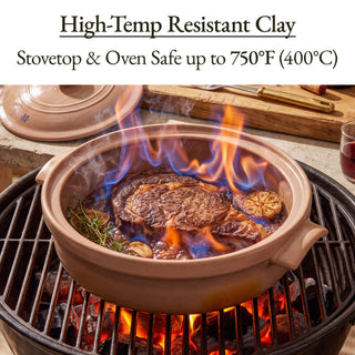 Brown Sugar Flami Pot Clay Dutch Oven searing a steak over open flames on a grill, stovetop and oven safe up to 750°F