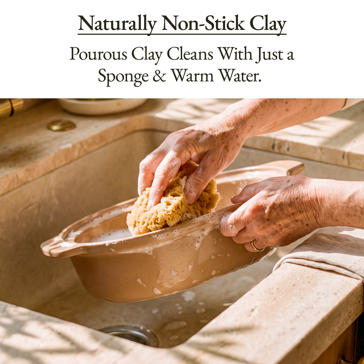 Person cleaning a Casserole Claypot Multi-Cooker with a sponge and warm water in a sink.